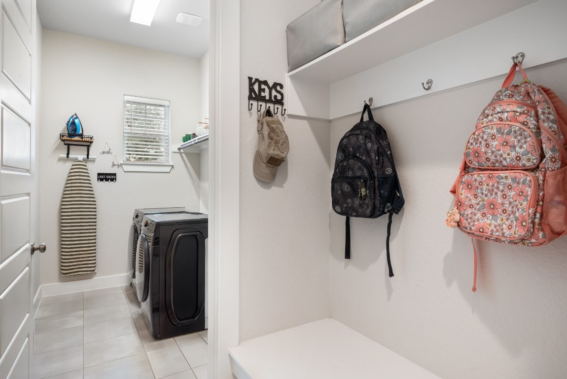216 Emerald Garden Road San Marcos, TX 78666 - Photo 31 of 38 Laundry area featuring washer and dryer and light tile patterned floors