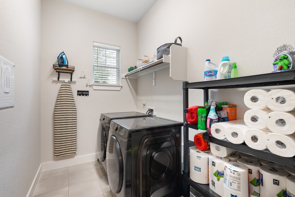 216 Emerald Garden Road San Marcos, TX 78666 - Photo 32 of 38 Laundry area with tile patterned floors and washer and dryer