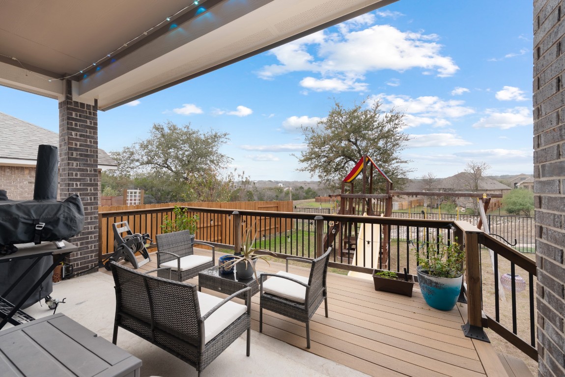 216 Emerald Garden Road San Marcos, TX 78666 - Photo 33 of 38 Deck featuring a playground, an outdoor living space, grilling area, and a fenced backyard