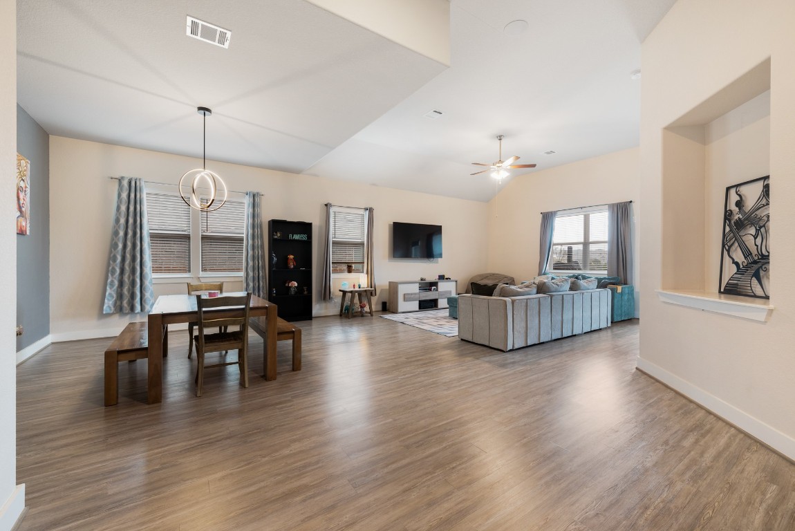 216 Emerald Garden Road San Marcos, TX 78666 - Photo 10 of 38 Living area with wood finished floors, a chandelier, a ceiling fan, and vaulted ceiling