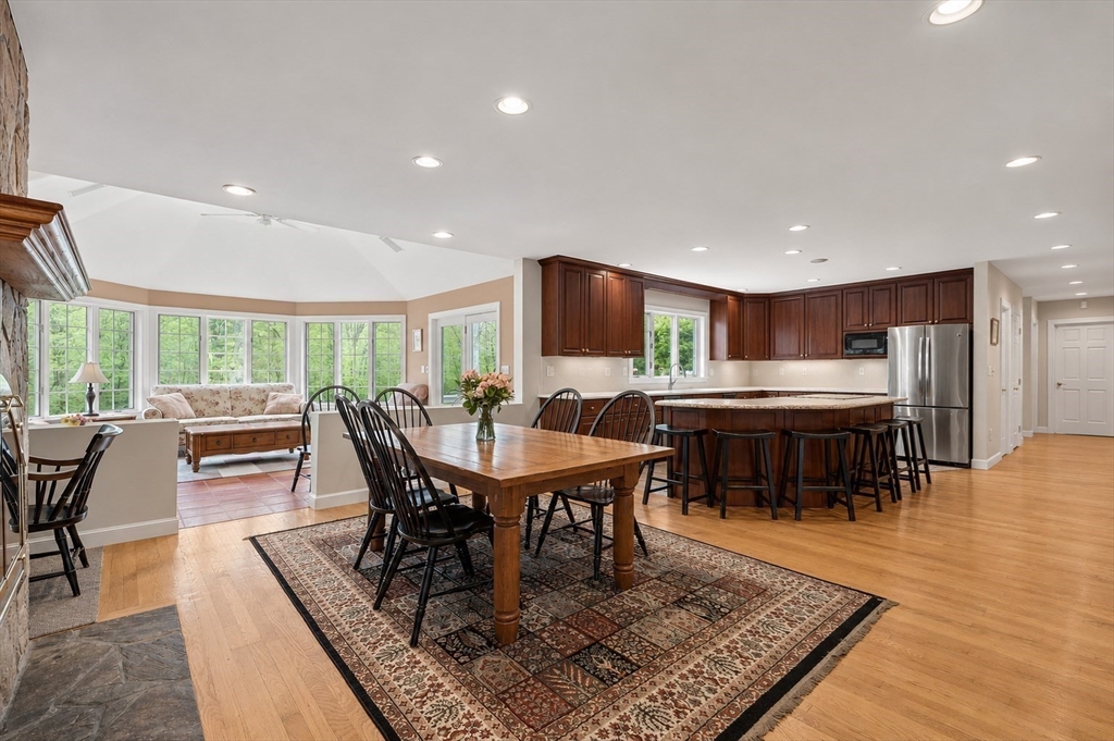 37 Old Planters Road Beverly, MA 01915 - Photo 15 of 42 a dining room with furniture a rug and a floor to ceiling window