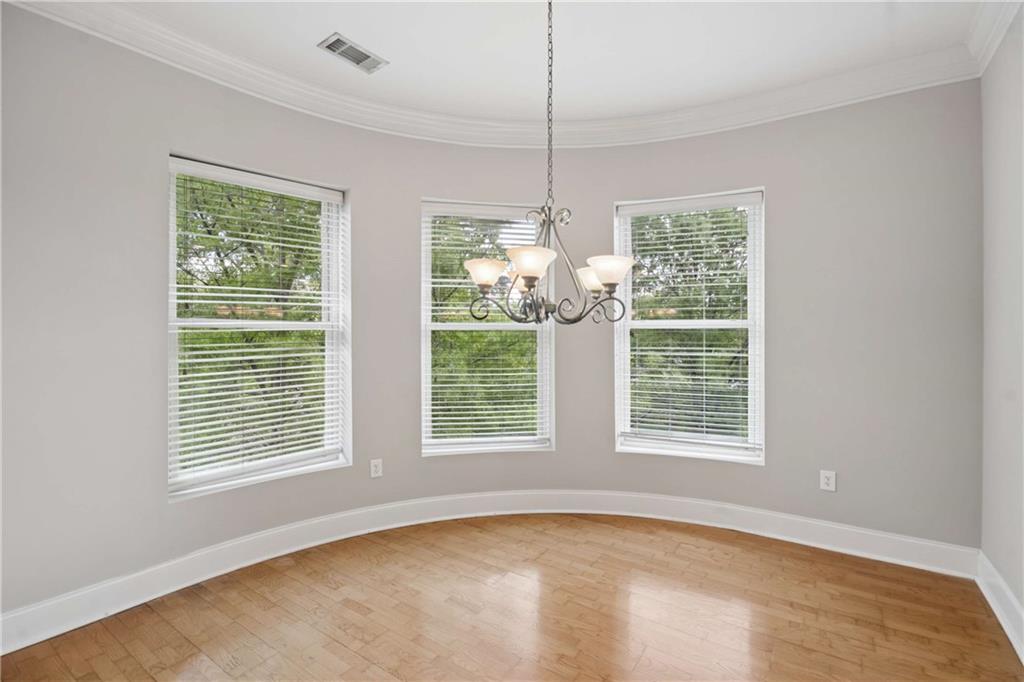 560 Dutch Valley Road Northeast, Unit 311 Atlanta, GA 30324 - Photo 13 of 44 a view of an empty room with a window and chandelier