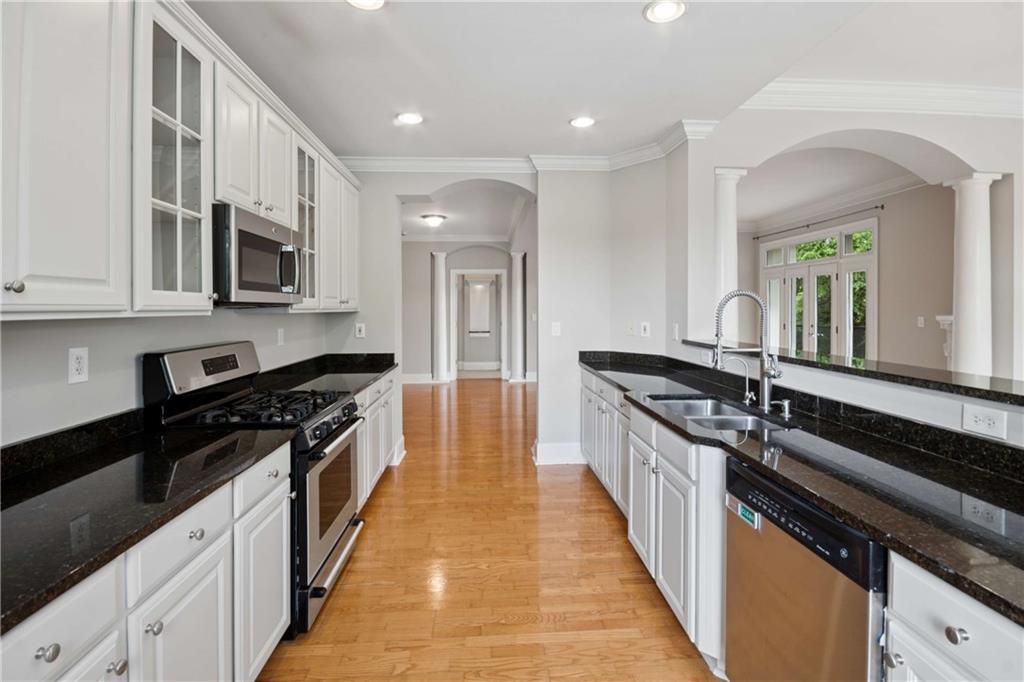 560 Dutch Valley Road Northeast, Unit 311 Atlanta, GA 30324 - Photo 15 of 44 a kitchen with stainless steel appliances a sink stove top oven and cabinets