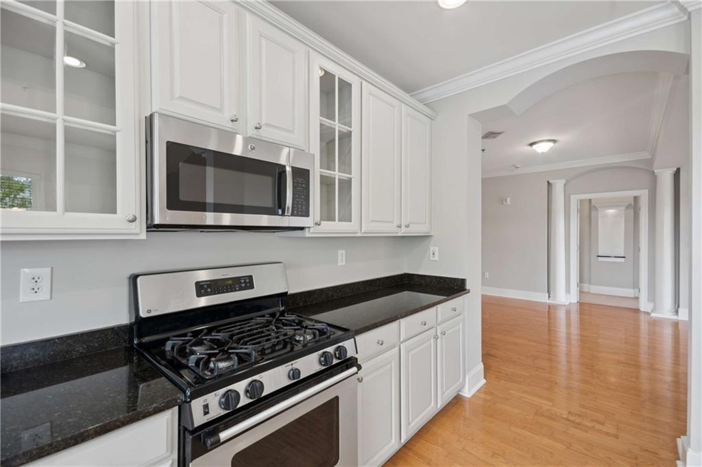 560 Dutch Valley Road Northeast, Unit 311 Atlanta, GA 30324 - Photo 16 of 44 a kitchen with stainless steel appliances granite countertop a stove and a microwave