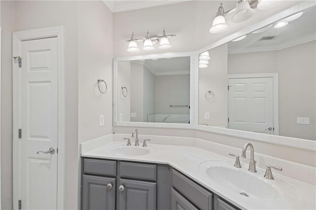 560 Dutch Valley Road Northeast, Unit 311 Atlanta, GA 30324 - Photo 25 of 44 a bathroom with a sink double vanity and a mirror