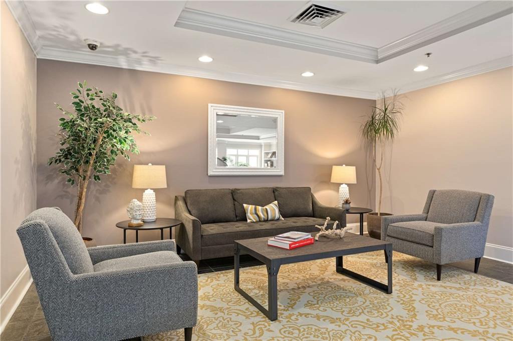 560 Dutch Valley Road Northeast, Unit 311 Atlanta, GA 30324 - Photo 33 of 44 a living room with furniture and a potted plant
