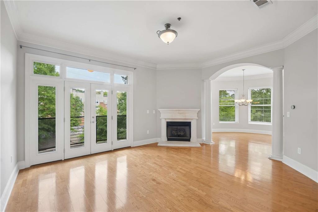 560 Dutch Valley Road Northeast, Unit 311 Atlanta, GA 30324 - Photo 9 of 44 a view of an empty room with windows and a fireplace