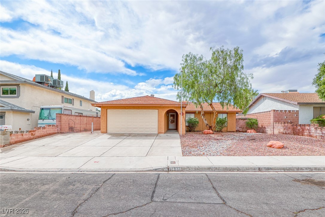 Ranch-style house with an attached garage, fence,