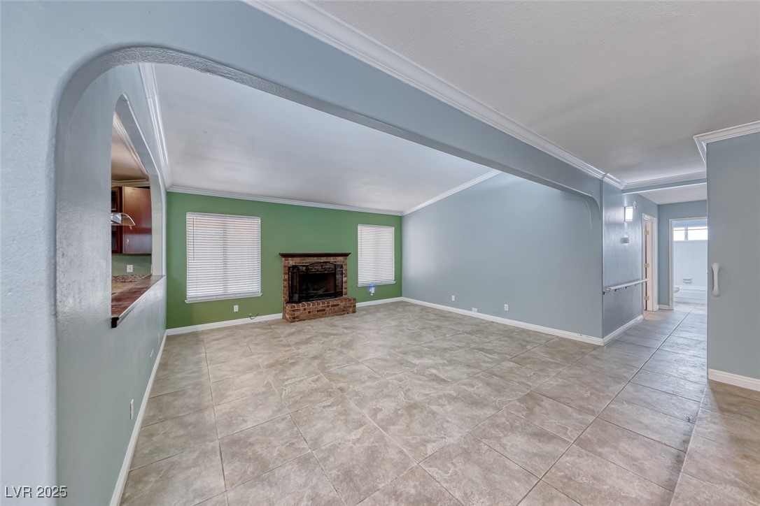 632 Arrayo Way Boulder City, NV 89005 - Photo 17 of 40 Unfurnished living room with crown molding, arched