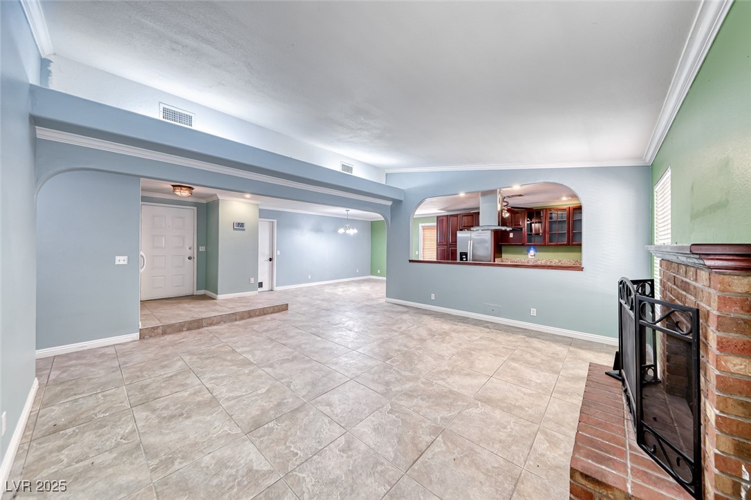 632 Arrayo Way Boulder City, NV 89005 - Photo 18 of 40 Unfurnished living room with crown molding, arched