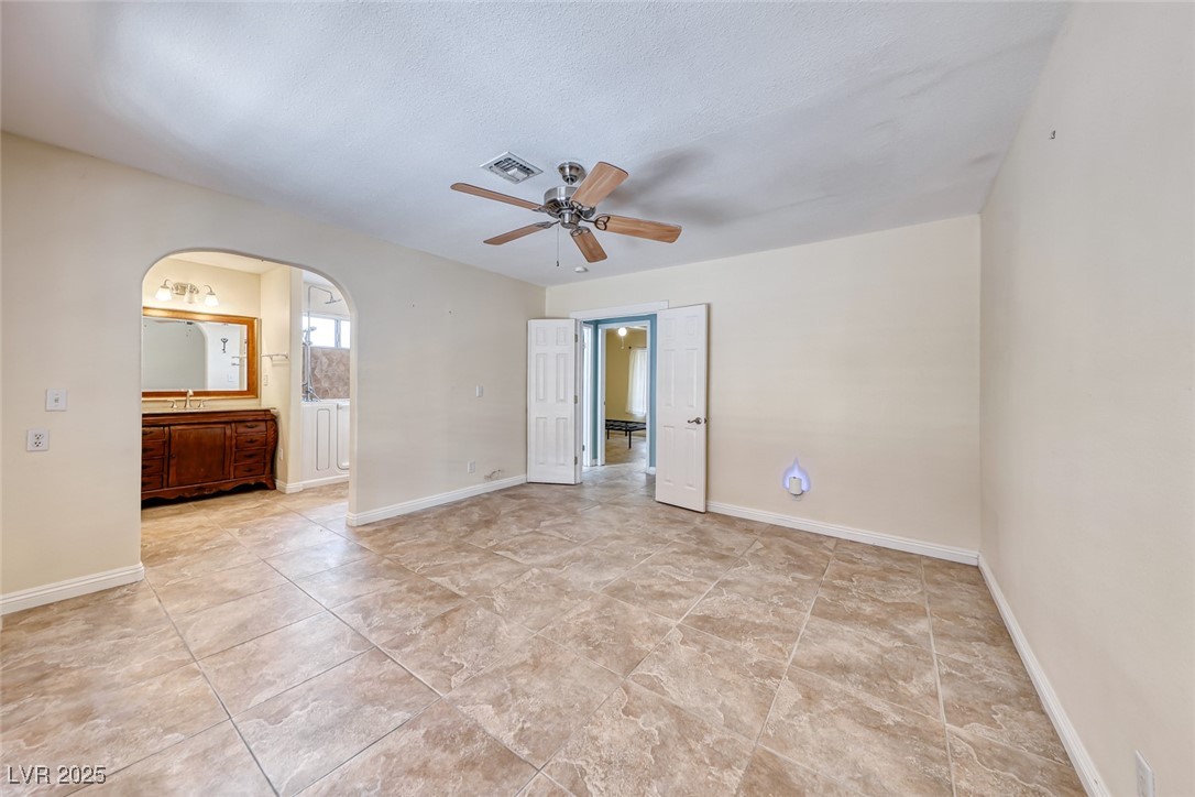 632 Arrayo Way Boulder City, NV 89005 - Photo 23 of 40 Spare room with a ceiling fan, arched walkways, an