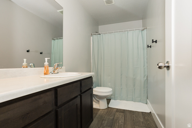 2452 West 500 South, Unit 2 Springville, UT 84663 - Photo 19 of 23 Bathroom featuring a dark wood-finish vanity with an integrated white sink, a chrome faucet, and a large wall-mounted mirror