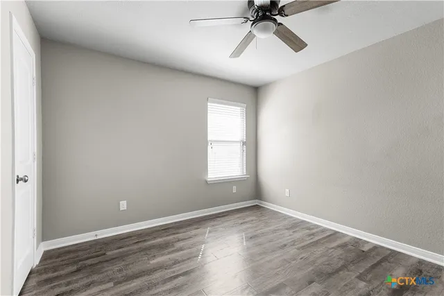 wooden floor in an empty room with a window