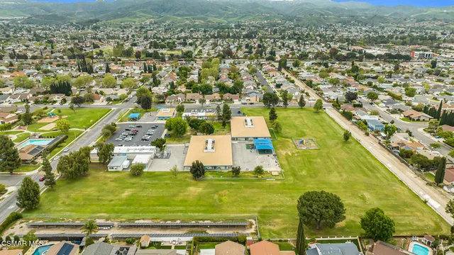 an aerial view of residential houses with city view