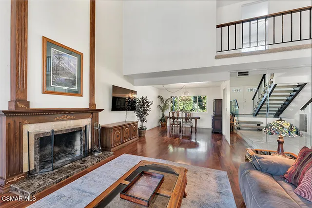 a living room with furniture a fireplace and a table