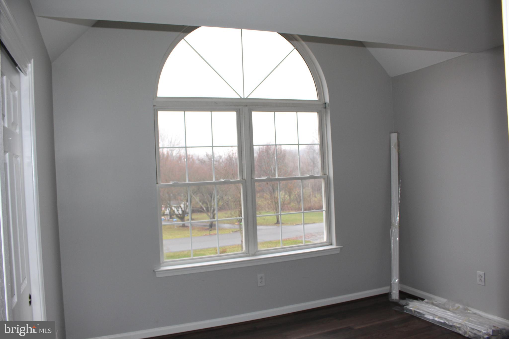 176 South Patricia Drive Swedesboro, NJ 08085 - Photo 41 of 61 an empty room with wooden floor and windows