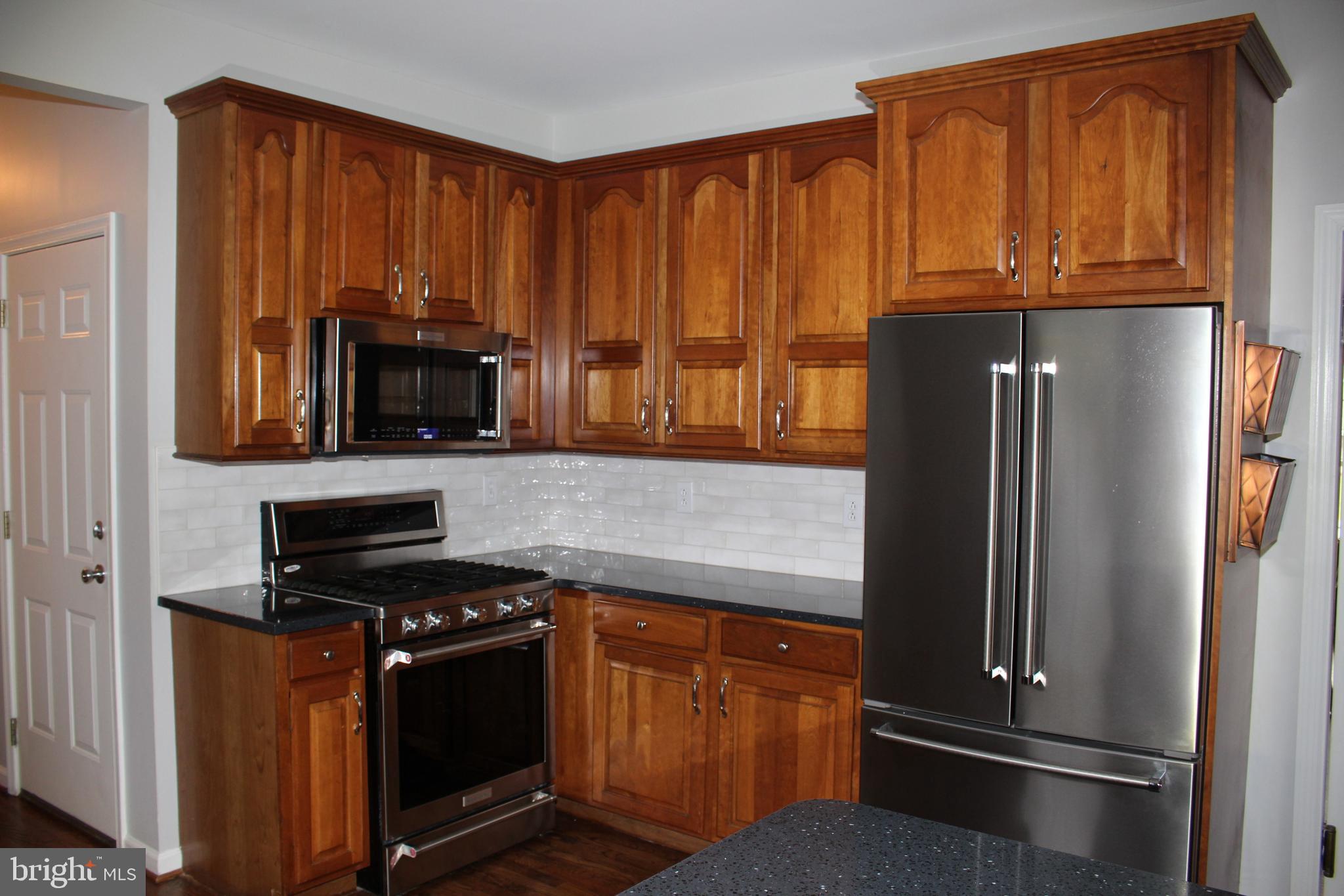 176 South Patricia Drive Swedesboro, NJ 08085 - Photo 55 of 61 a kitchen with granite countertop a refrigerator stove and microwave