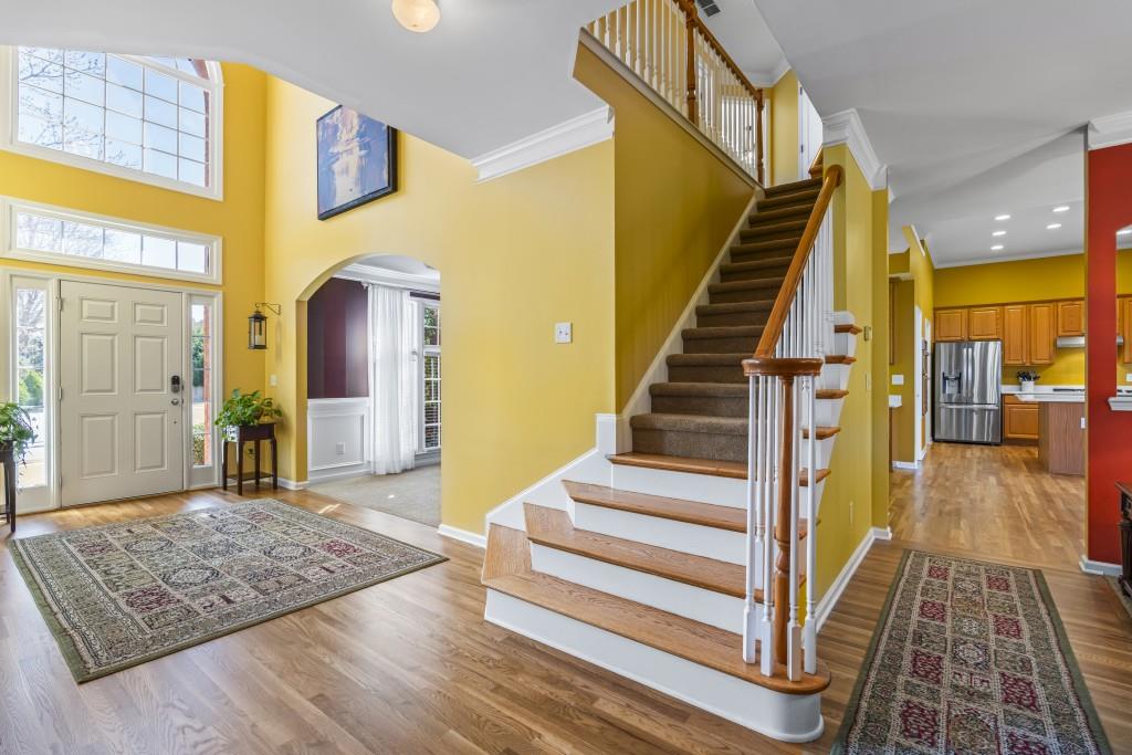 466 Middleton Place Grayson, GA 30017 - Photo 4 of 106 a view of a hallway with wooden floor and staircase