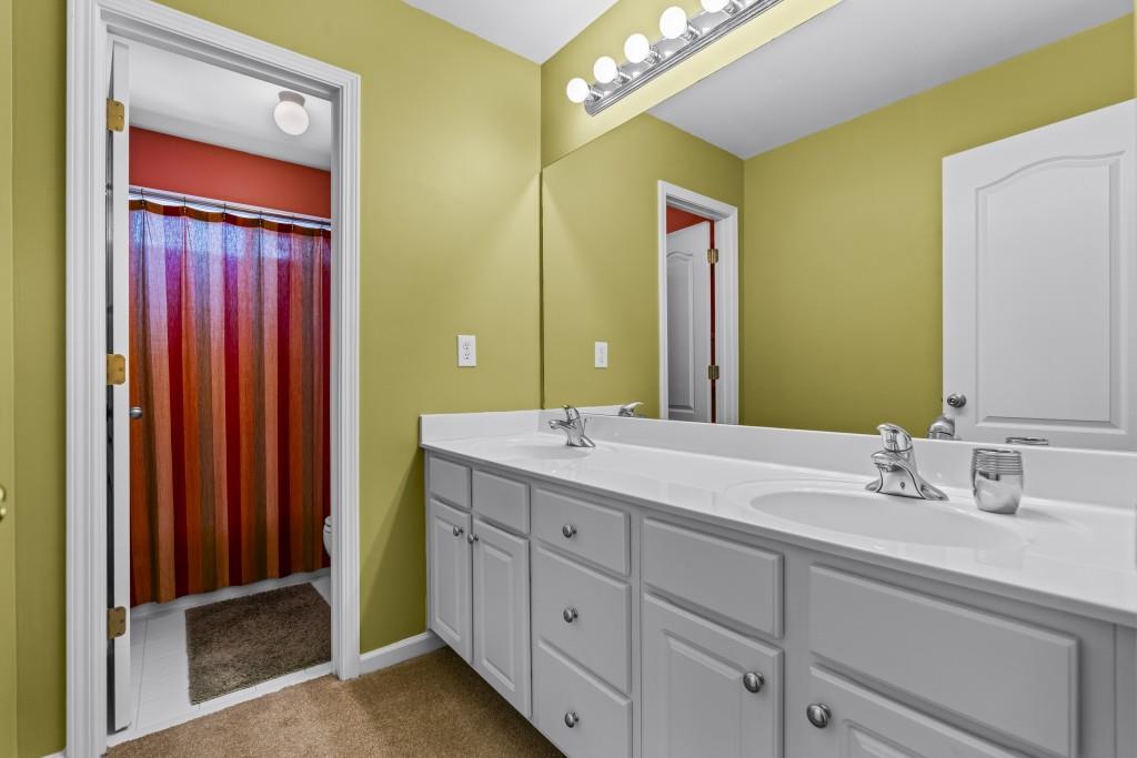 466 Middleton Place Grayson, GA 30017 - Photo 48 of 106 a bathroom with a double vanity sink and a mirror