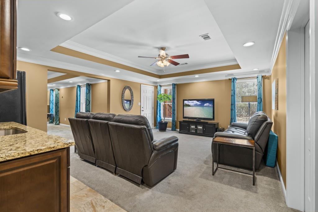 466 Middleton Place Grayson, GA 30017 - Photo 52 of 106 a living room with furniture and a flat screen tv