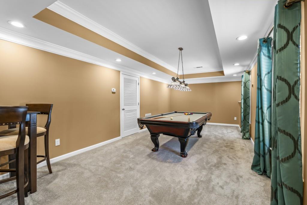 466 Middleton Place Grayson, GA 30017 - Photo 58 of 106 a room with furniture and a chandelier