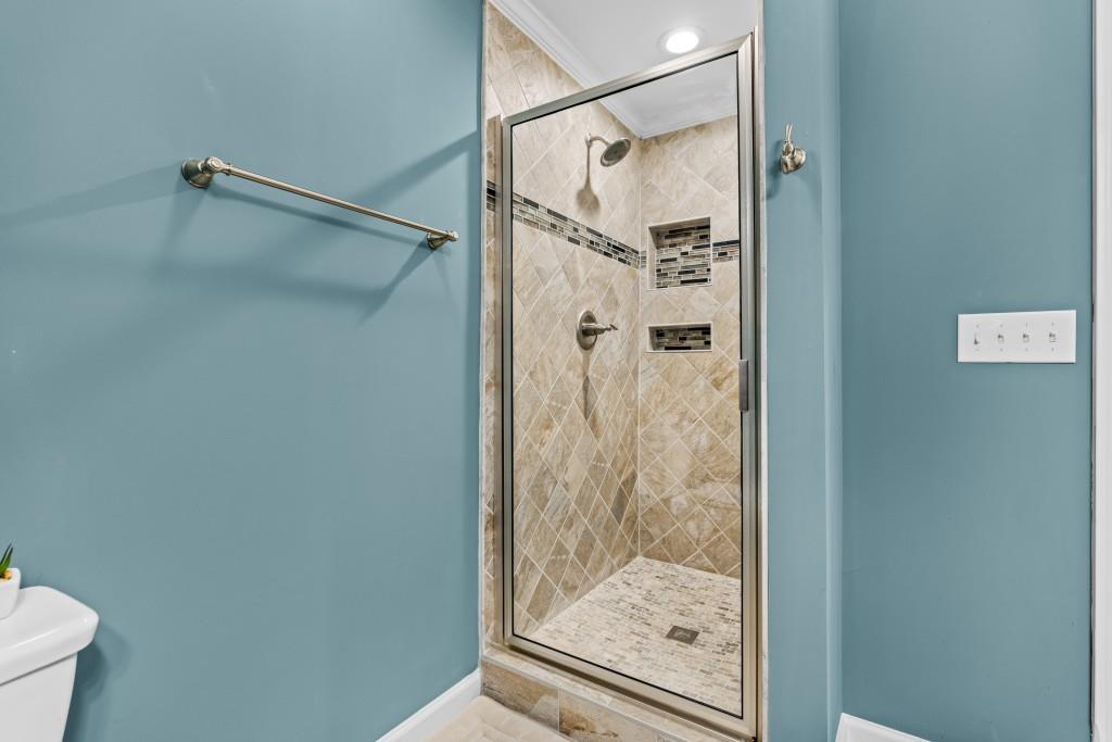 466 Middleton Place Grayson, GA 30017 - Photo 67 of 106 a bathroom with a glass shower door