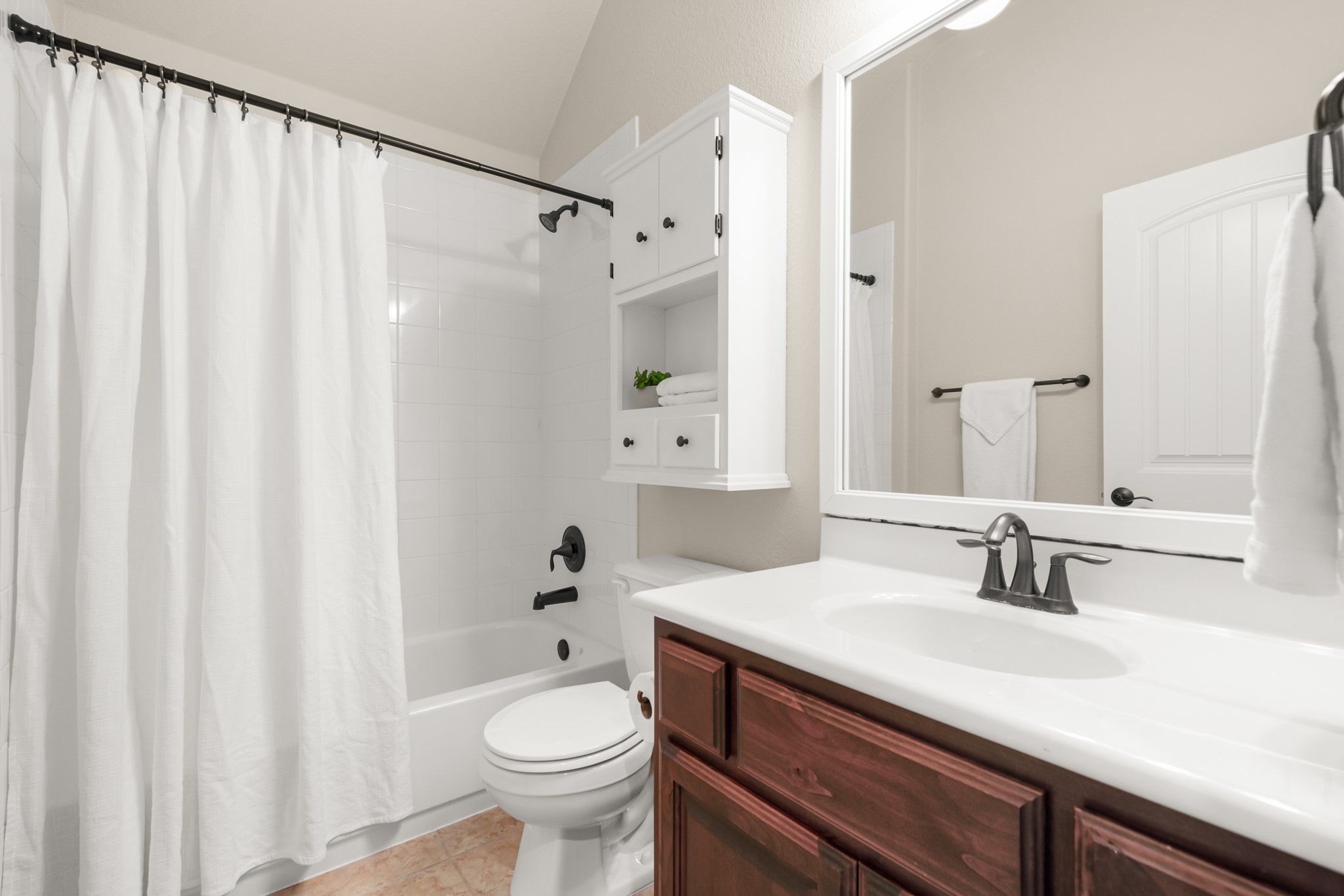 1906 Tall Chief Leander, TX 78641 - Photo 11 of 38 a bathroom with a sink a toilet and a mirror