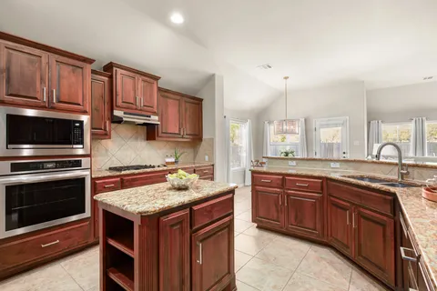 a kitchen with a sink stove and microwave