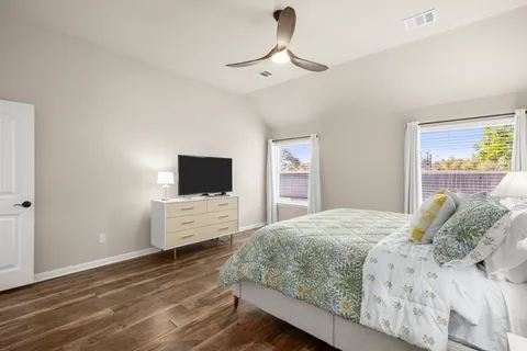 a bedroom with a bed and a flat screen tv