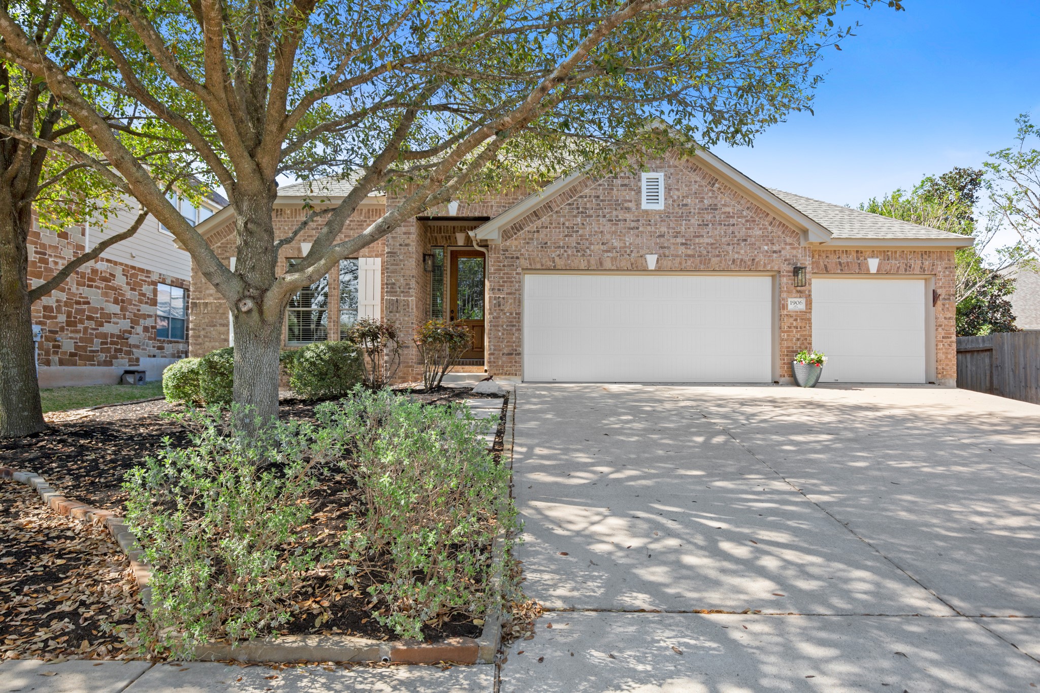 1906 Tall Chief Leander, TX 78641 - Photo 2 of 38 a front view of a house with a yard and garage