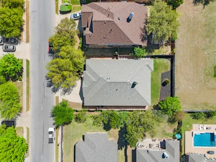 an aerial view of residential houses with outdoor space