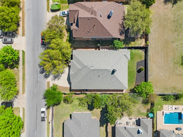 an aerial view of residential houses with outdoor space