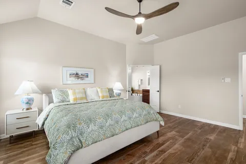 a bedroom with a large bed and a lamp on table