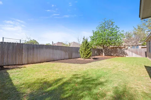 a view of swimming pool with wooden fence