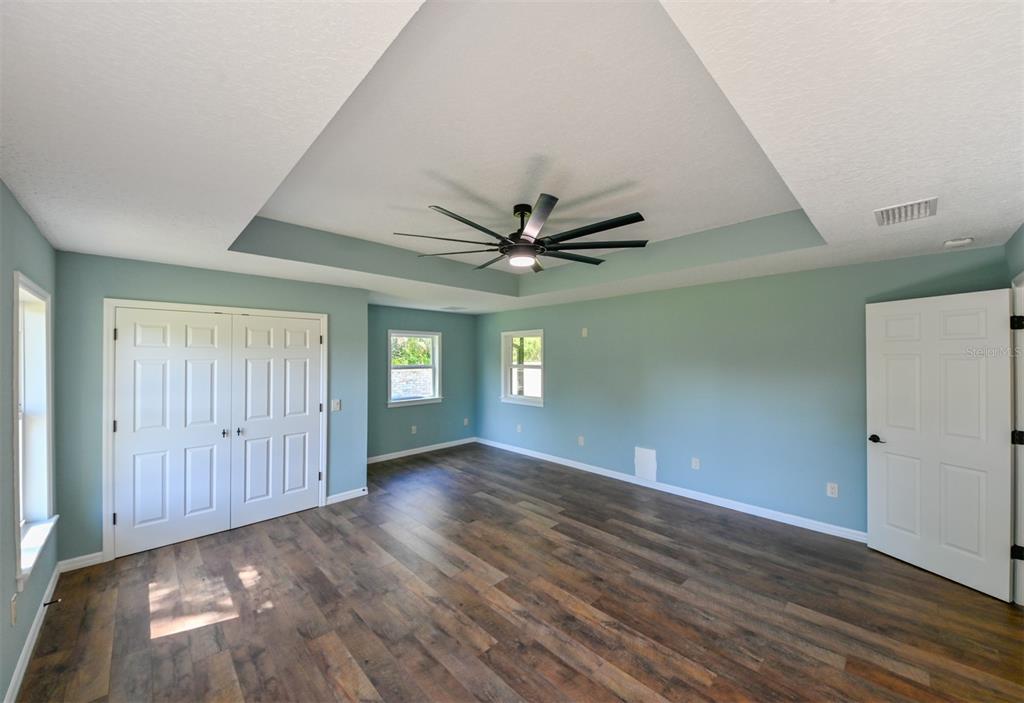 5430 West Tortuga Loop Lecanto, FL 34461 - Photo 13 of 51 a view of an empty room with window and wooden floor