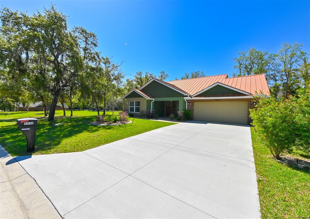 5430 West Tortuga Loop Lecanto, FL 34461 - Photo 44 of 51 a front view of a house with a yard