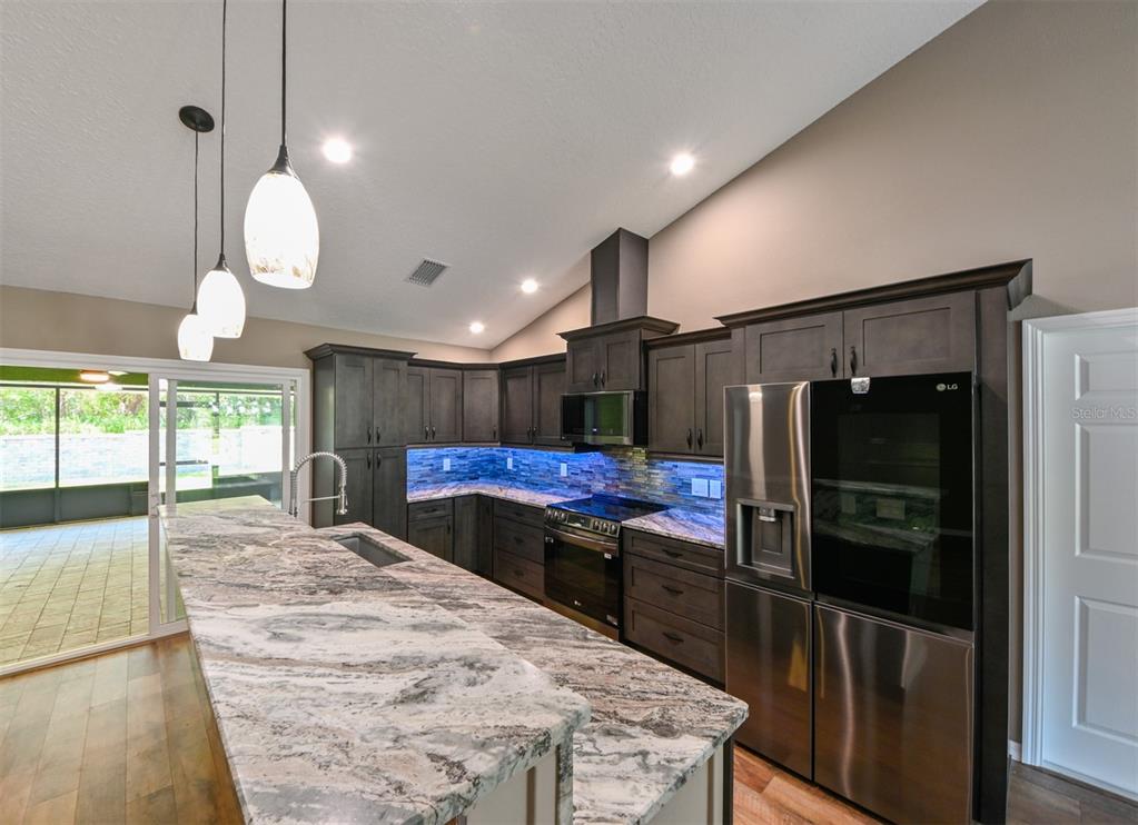5430 West Tortuga Loop Lecanto, FL 34461 - Photo 5 of 51 a kitchen with stainless steel appliances granite countertop a refrigerator a oven a sink and a refrigerator