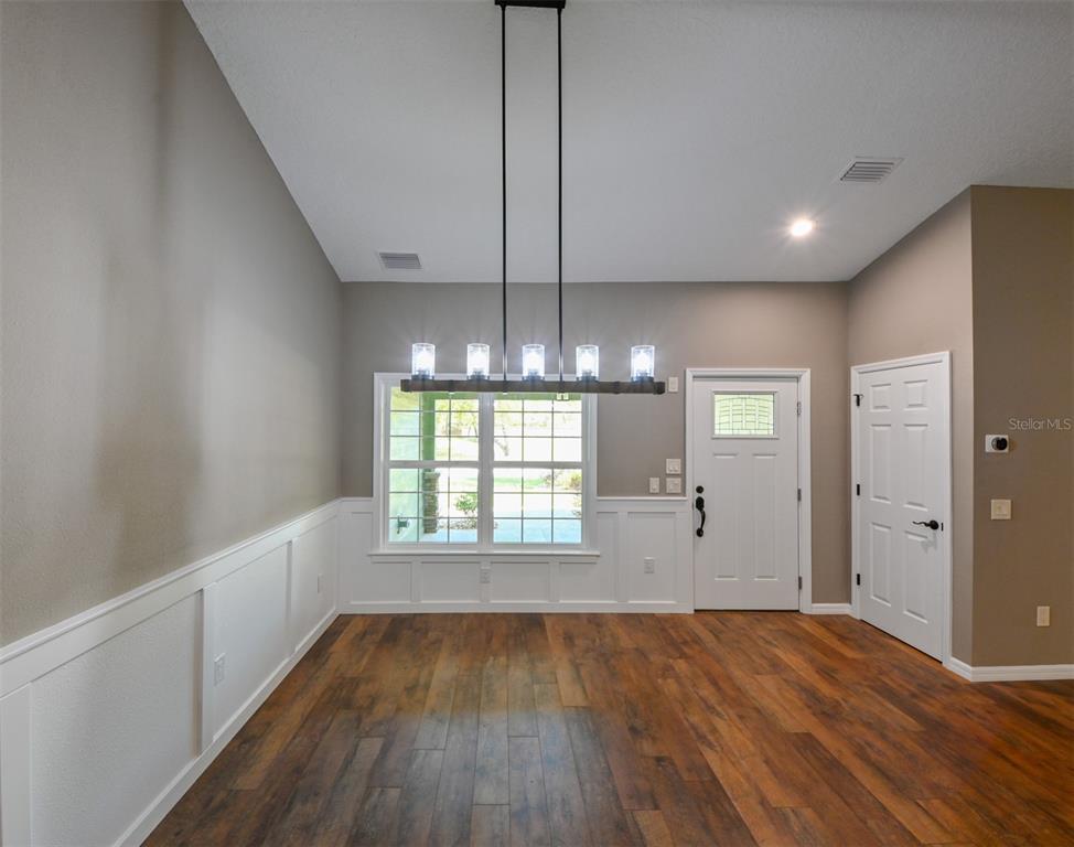 5430 West Tortuga Loop Lecanto, FL 34461 - Photo 8 of 51 a view of an empty room with wooden floor and a window