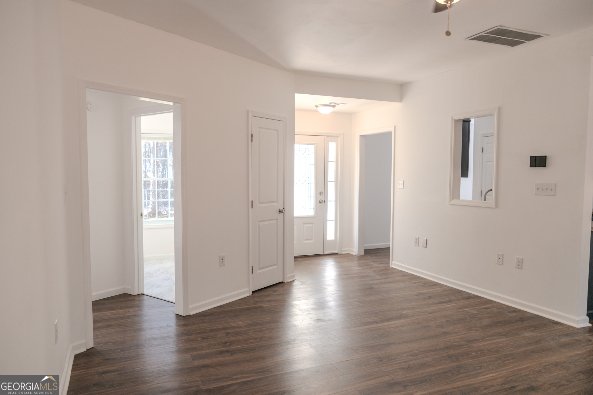 55 Corn Row Court Newnan, GA 30263 - Photo 16 of 72 an empty room with wooden floor and windows