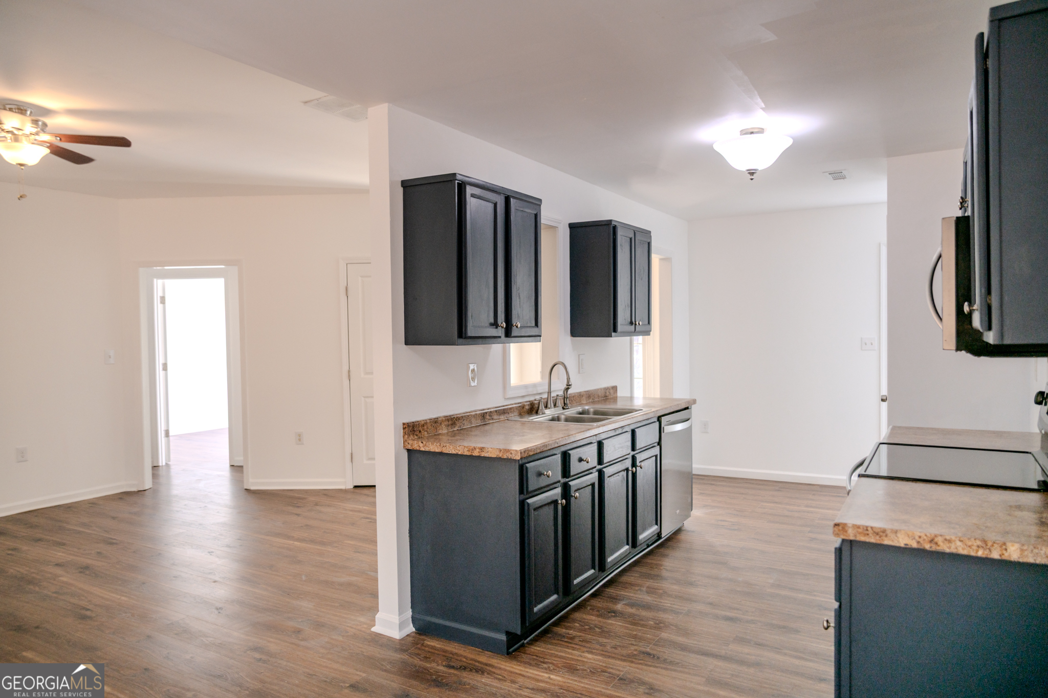 55 Corn Row Court Newnan, GA 30263 - Photo 18 of 72 a kitchen with stainless steel appliances granite countertop a stove and a sink