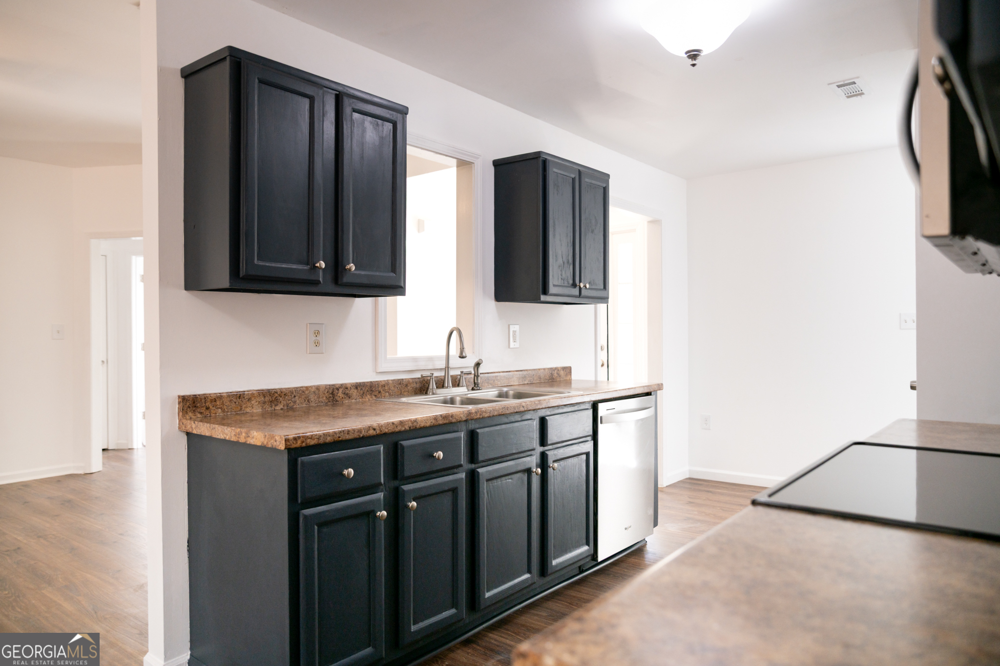 55 Corn Row Court Newnan, GA 30263 - Photo 21 of 72 a kitchen with a sink and a refrigerator