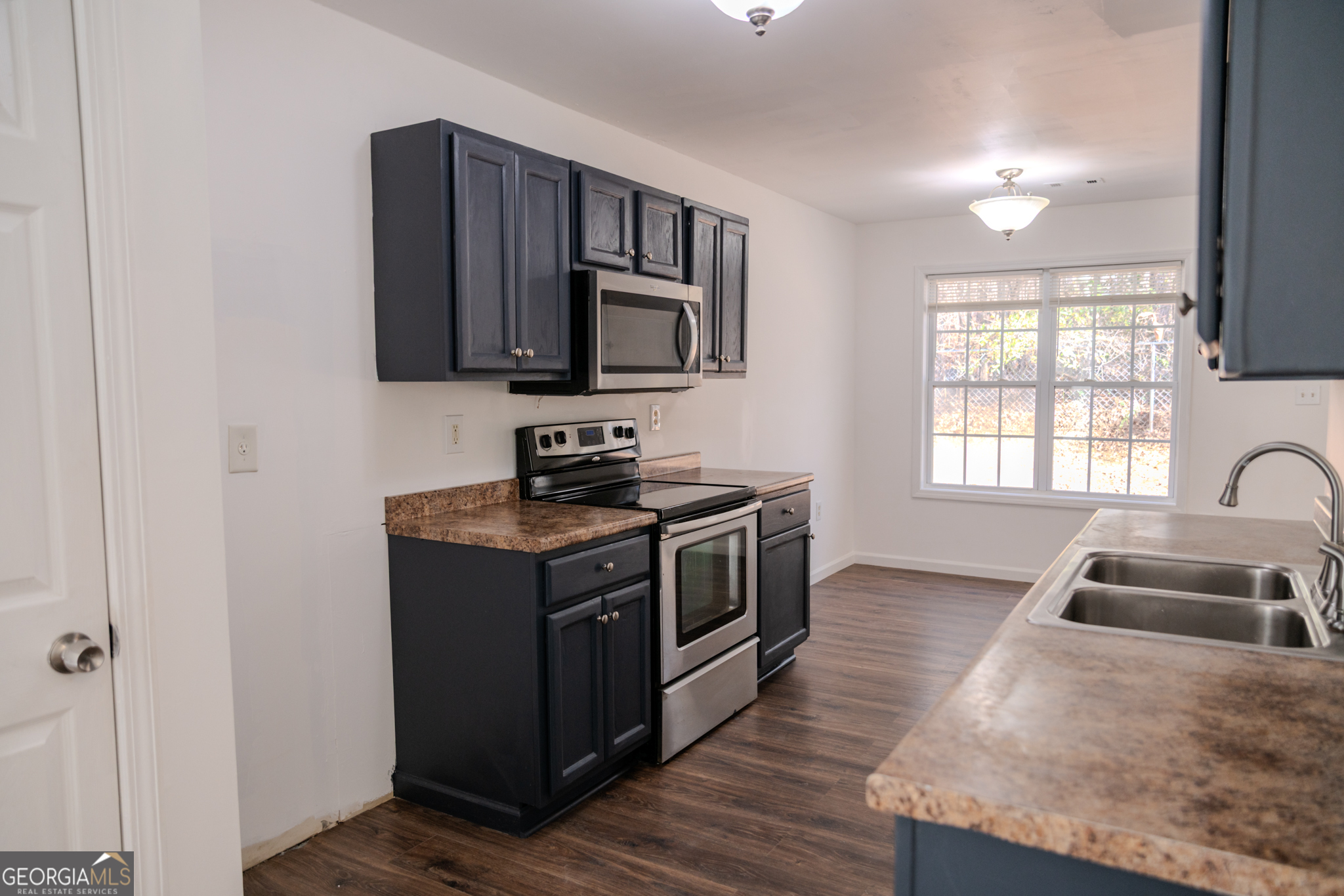 55 Corn Row Court Newnan, GA 30263 - Photo 22 of 72 a kitchen with stainless steel appliances granite countertop a sink stove and microwave
