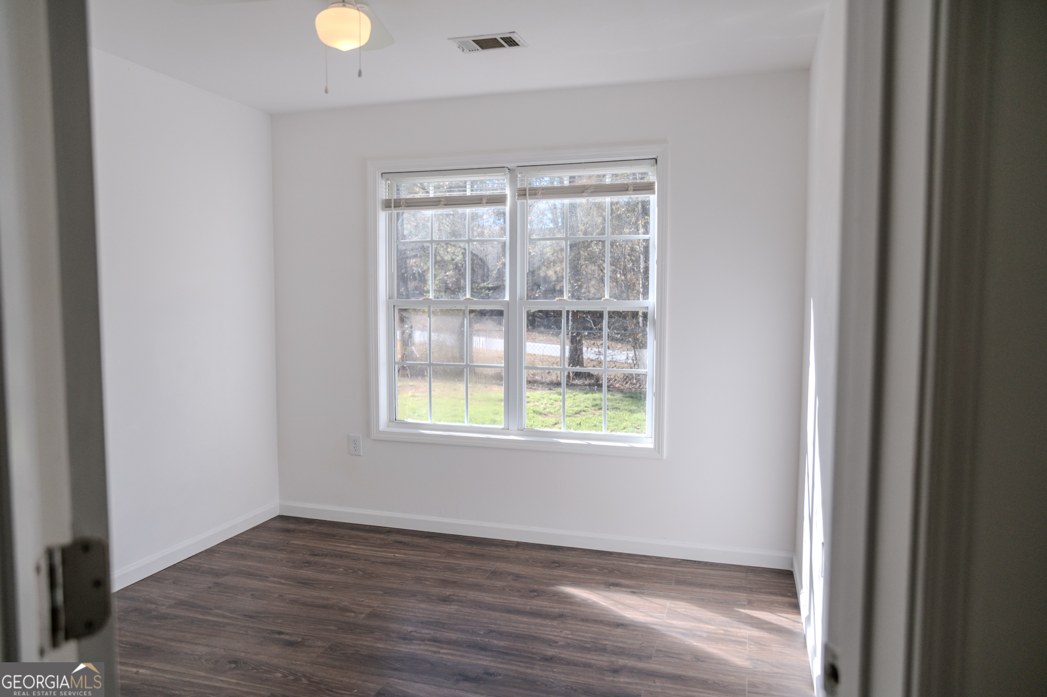 55 Corn Row Court Newnan, GA 30263 - Photo 28 of 72 an empty room with wooden floor and windows