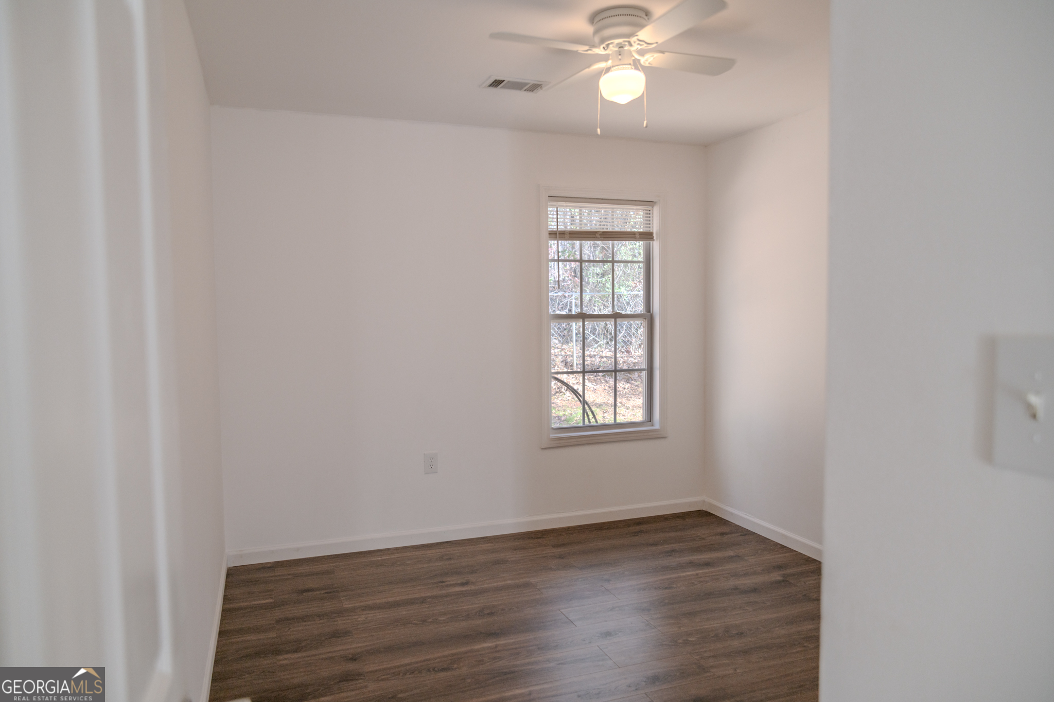 55 Corn Row Court Newnan, GA 30263 - Photo 29 of 72 an empty room with wooden floor fan and windows