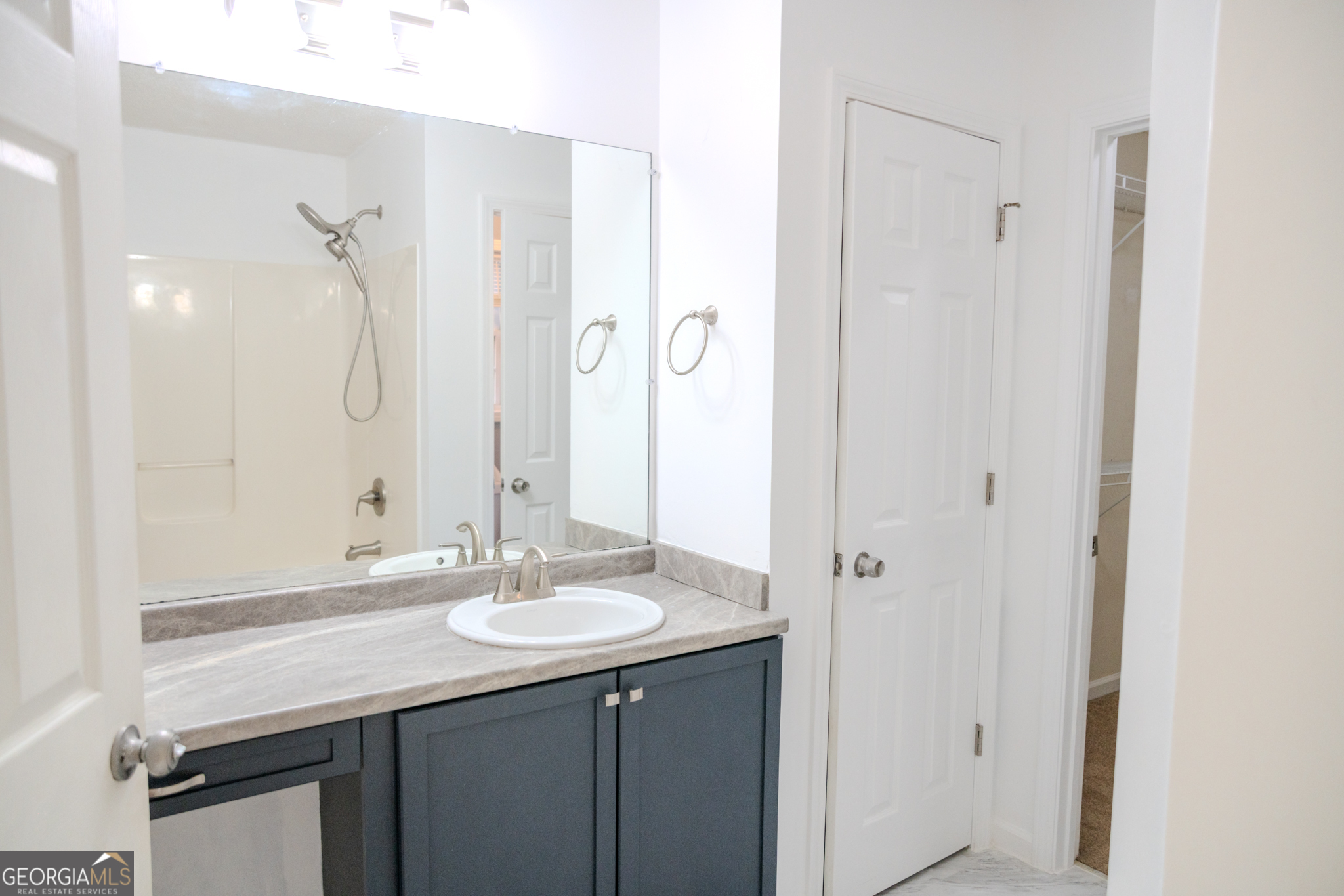 55 Corn Row Court Newnan, GA 30263 - Photo 57 of 72 a bathroom with a granite countertop sink a mirror and a shower