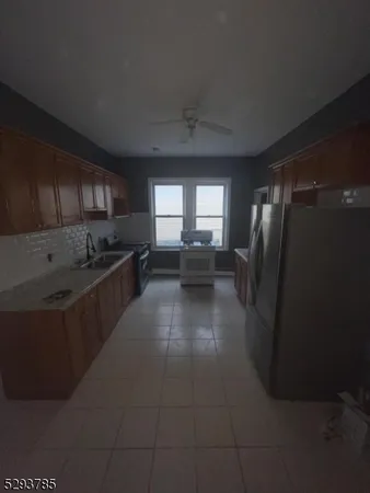 a kitchen with stainless steel appliances granite countertop a refrigerator a stove a sink and dishwasher