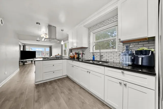 a kitchen with stainless steel appliances granite countertop a sink and cabinets