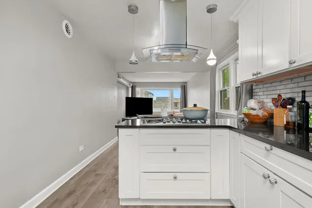 a view of bedroom with natural light and hardwood floor
