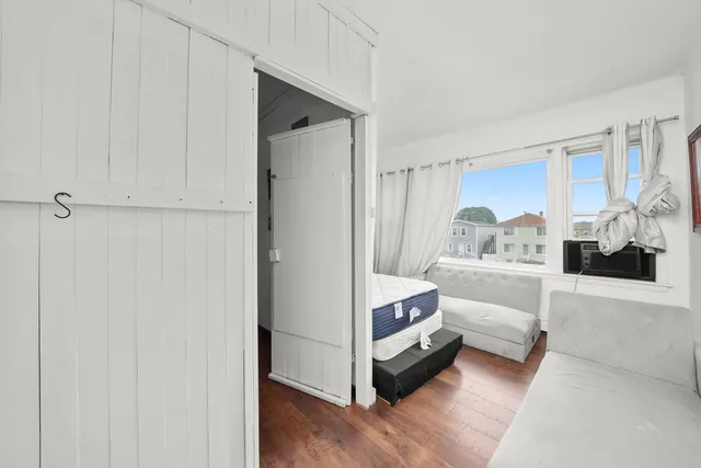 a bedroom with a bed and a window