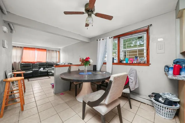 a dining room with furniture and a kitchen view